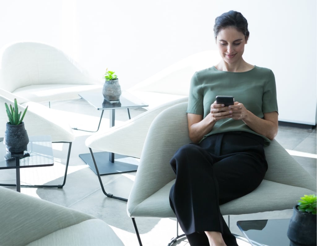 female executive using mobile phone on chair