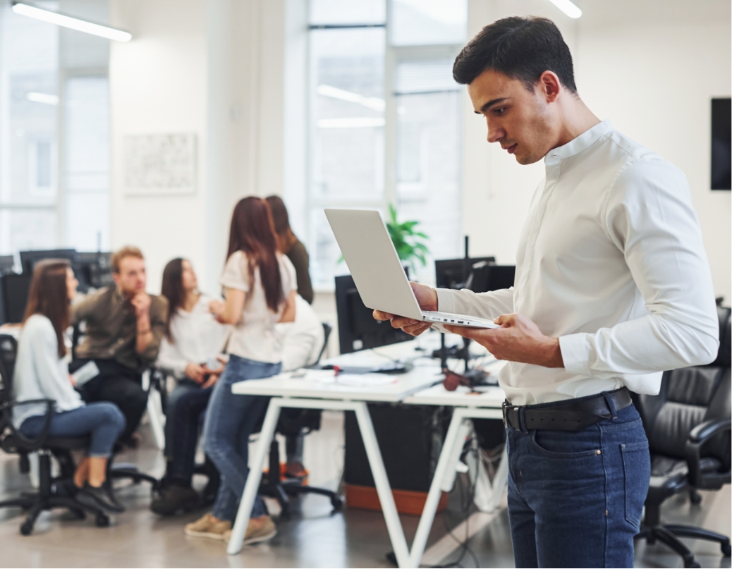 man in formal wear standing with laptop in hands i 387PDRS@2x