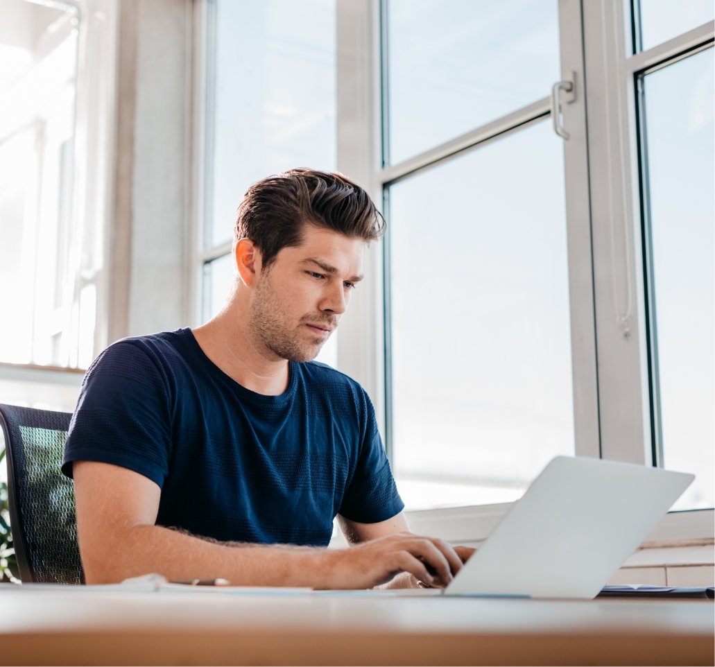 young male executive working on laptop